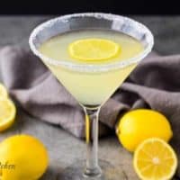 The lemon drop martini in a martini glass rimmed with sugar.