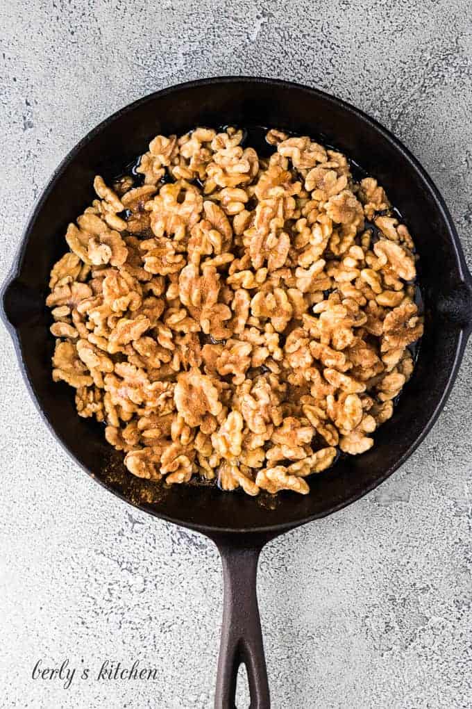 The walnuts and other ingredients in a cast iron skillet.