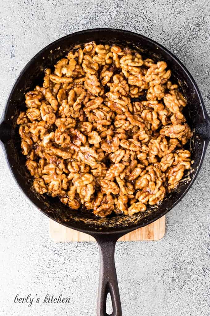 The nuts and maple syrup have cooked in the pan.