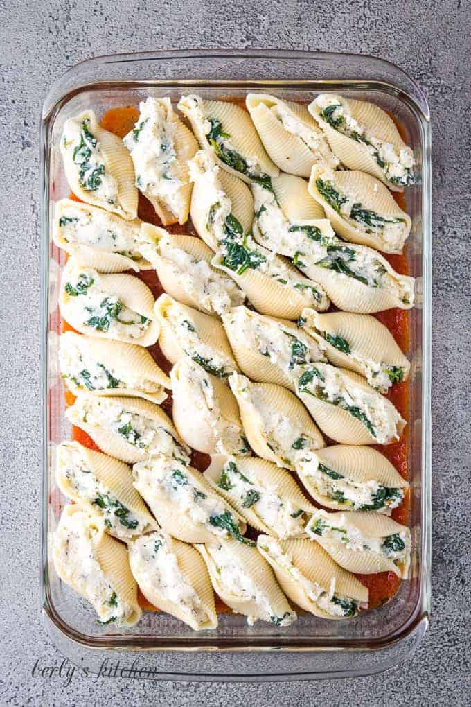 The shells have been stuffed and placed into a baking dish.