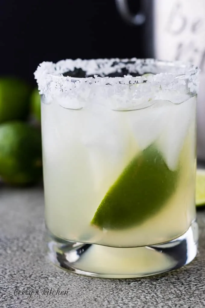 The tequila cocktail in a glass with a salted rim.