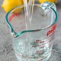 The finished syrup mixture pouring into a glass measuring cup.