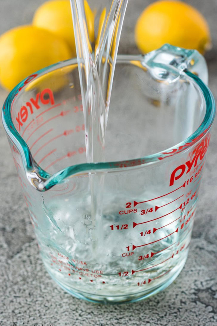 The finished syrup mixture pouring into a glass measuring cup.
