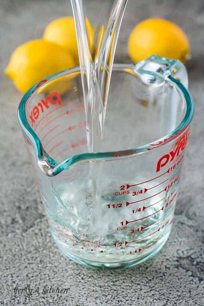 The finished syrup mixture pouring into a glass measuring cup.