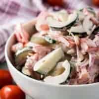 The creamy tomato onion cucumber salad in a bowl.