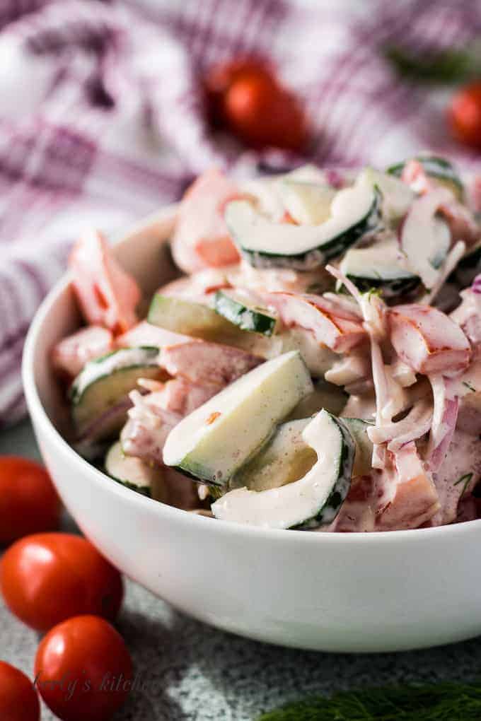 The creamy tomato onion cucumber salad in a bowl.