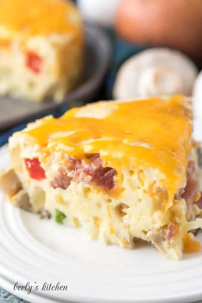 A piece of the Instant Pot frittata topped with melted cheese.