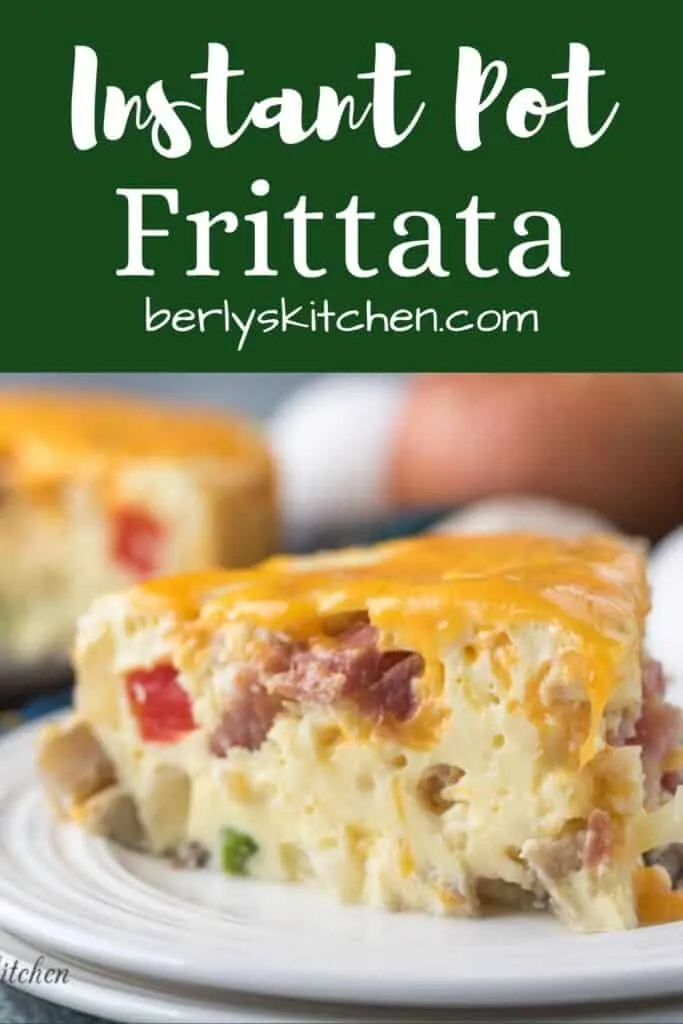 A piece of the ham frittata topped with melted cheddar.