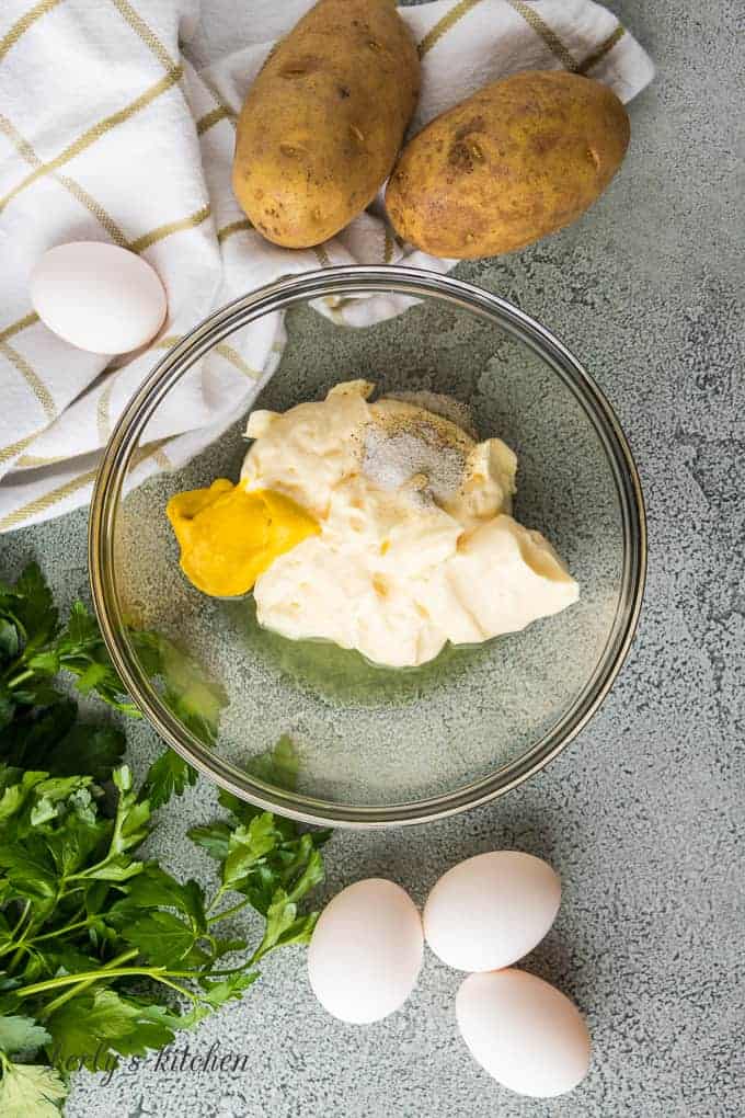 Ariel view of mayonnaise, pickle juice, mustard, salt and pepper for dressing.