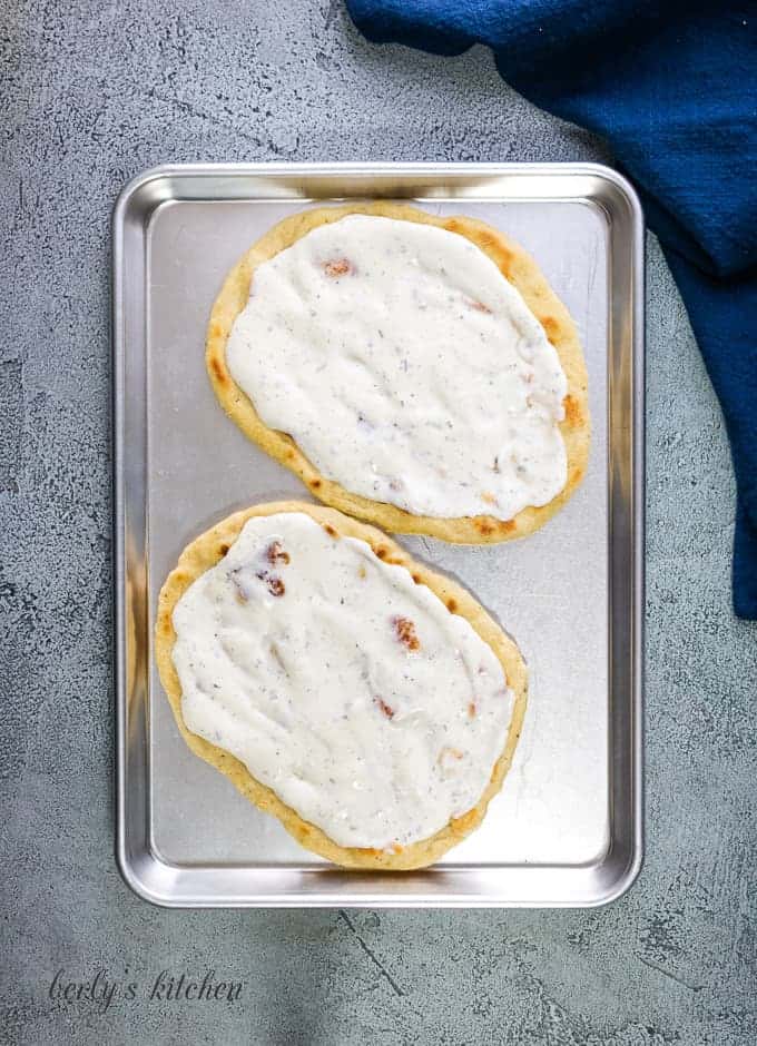 Ranch dressing spread evenly over the flatbread.