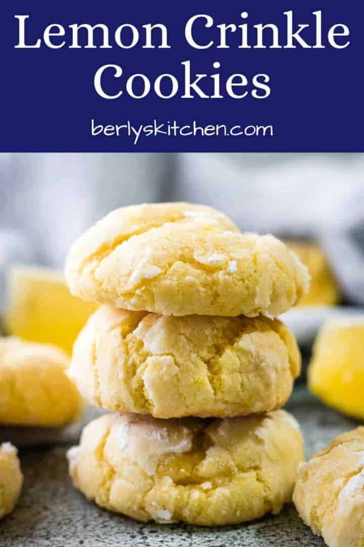 Three lemon crinkle cookies dusted with powdered sugar.