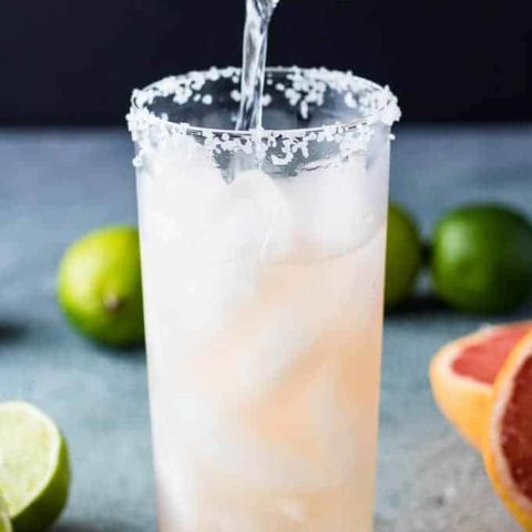 Tequila being added to the grapefruit juice.