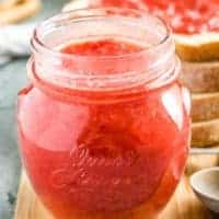 The sunday morning strawberry jam recipe served in a mason jar.