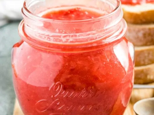 The sunday morning strawberry jam recipe served in a mason jar.