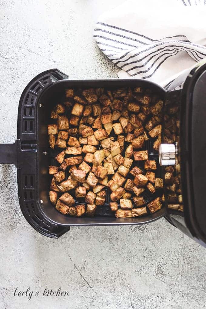 The home fries have cooked in the basket.