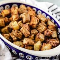 The seasoned air fryer home fries in an oval bowl.
