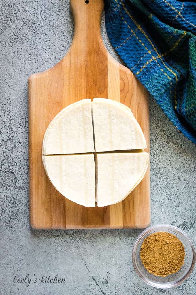 A stack of corn tortillas cut into quarters.