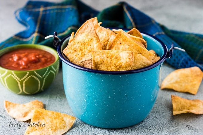 A blue kettle filled with air fryer tortilla chips.