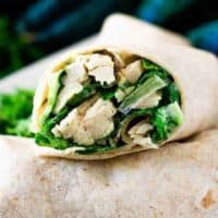 A close-up of a sliced chicken wrap showing the filling.