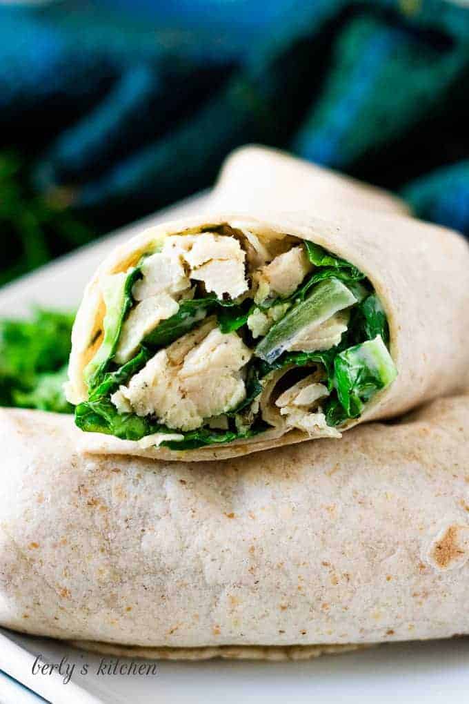 A close-up of a sliced chicken wrap showing the filling.