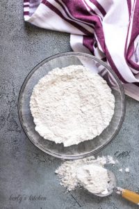 A large mixing bowl filled with flour and other dry ingredients.