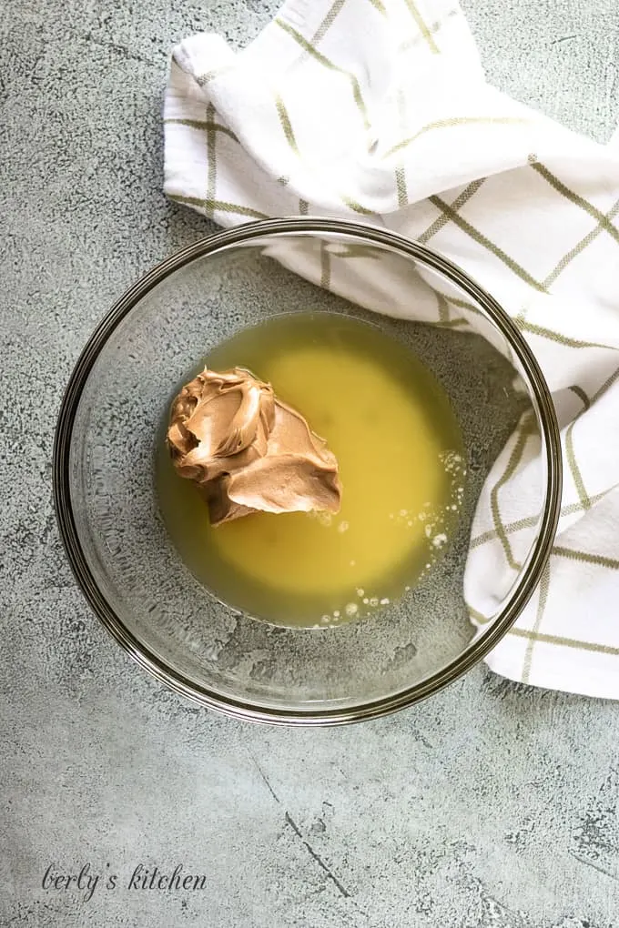 Melted butter and peanut butter in a mixing bowl.