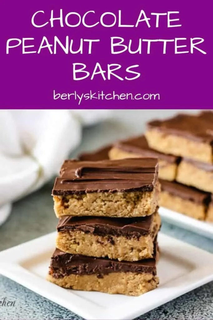 Three no bake chocolate peanut butter bars stacked on a square plate.