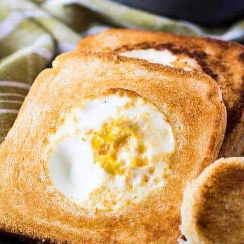 A close-up of the eggs and toast on a plate.