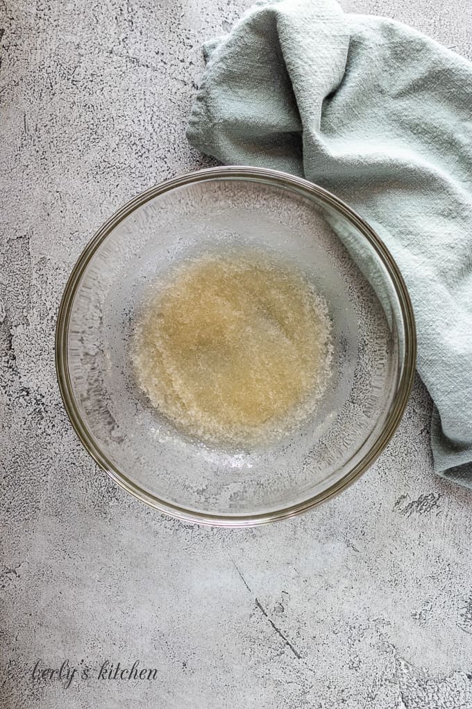 Gelatin and water in a large glass mixing bowl.