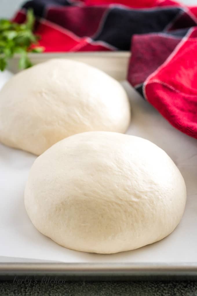The pizza dough is separated and ready to be stretched.