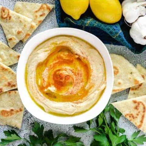 An aerial view of the roasted garlic hummus served with flatbread.