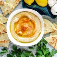 An aerial shot of the roasted garlic hummus served with flatbread.