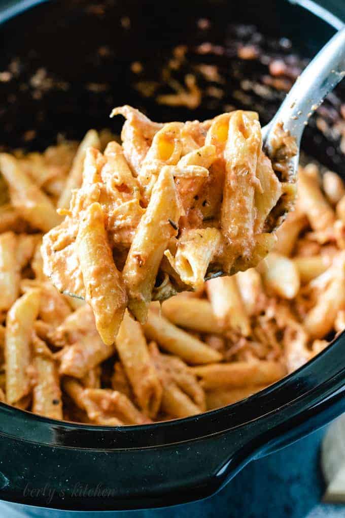 A big scoop of the finished pasta on a metal spoon.