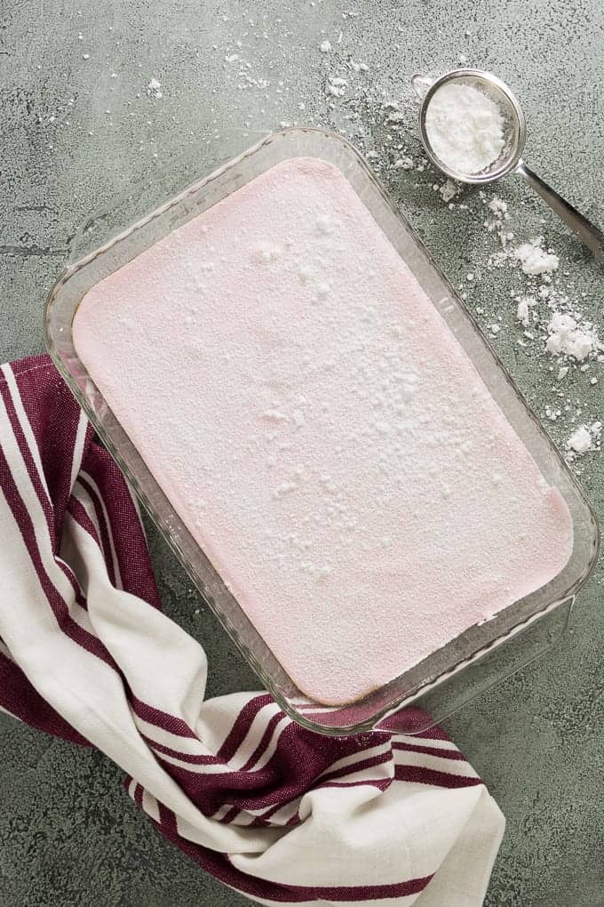 The homemade strawberry marshmallows have set and are ready to cut.