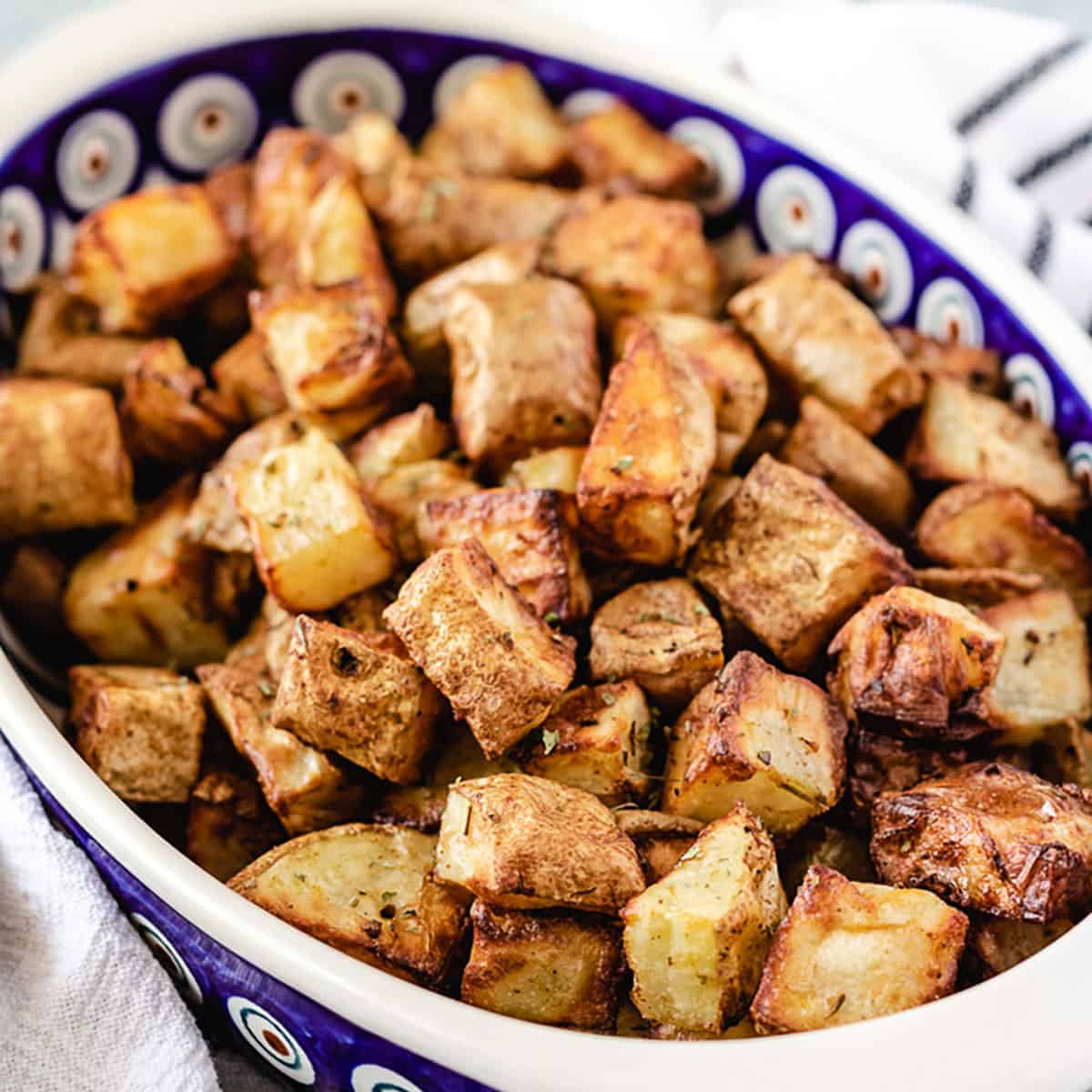 Air fryer home fries in a blue and white dish.