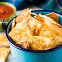 Blue bucket filled with homemade tortilla chips.