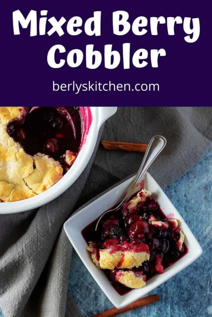 A serving of the mixed berry cobbler in a square bowl.