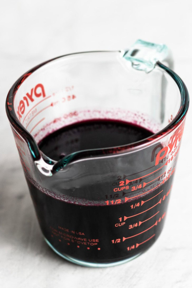 The mixture has been strained into a measuring cup.