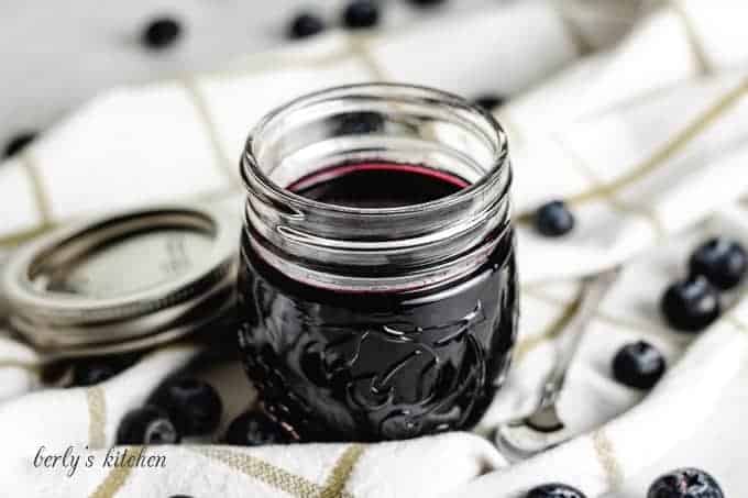 A small mason jar filled with the blueberry simple syrup.