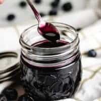 A small spoon being dipped into the simple syrup.