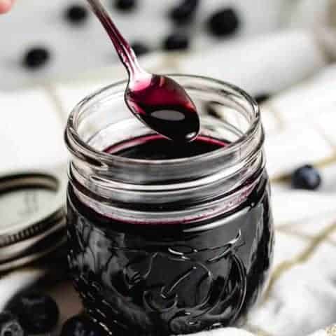 A small spoon being dipped into the simple syrup.