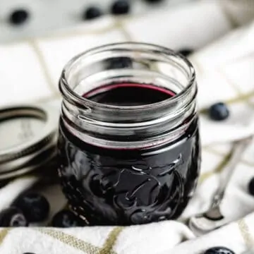 The blueberry simple syrup in a mason jar.