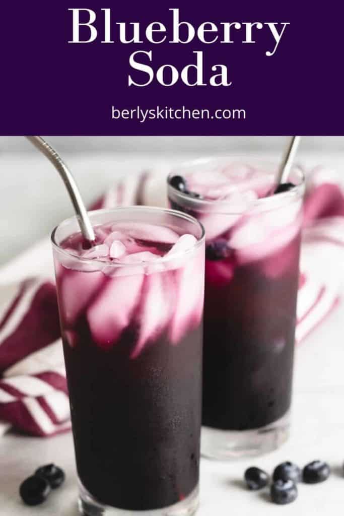 Blueberry sodas with ice, straws, and fresh blueberries.