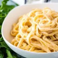 White bowl filled with spicy fettuccine Alfredo.