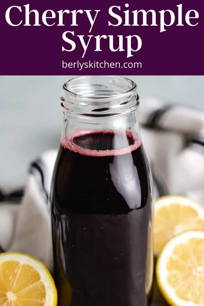 A close-up of the cherry drink syrup in a decorative bottle.