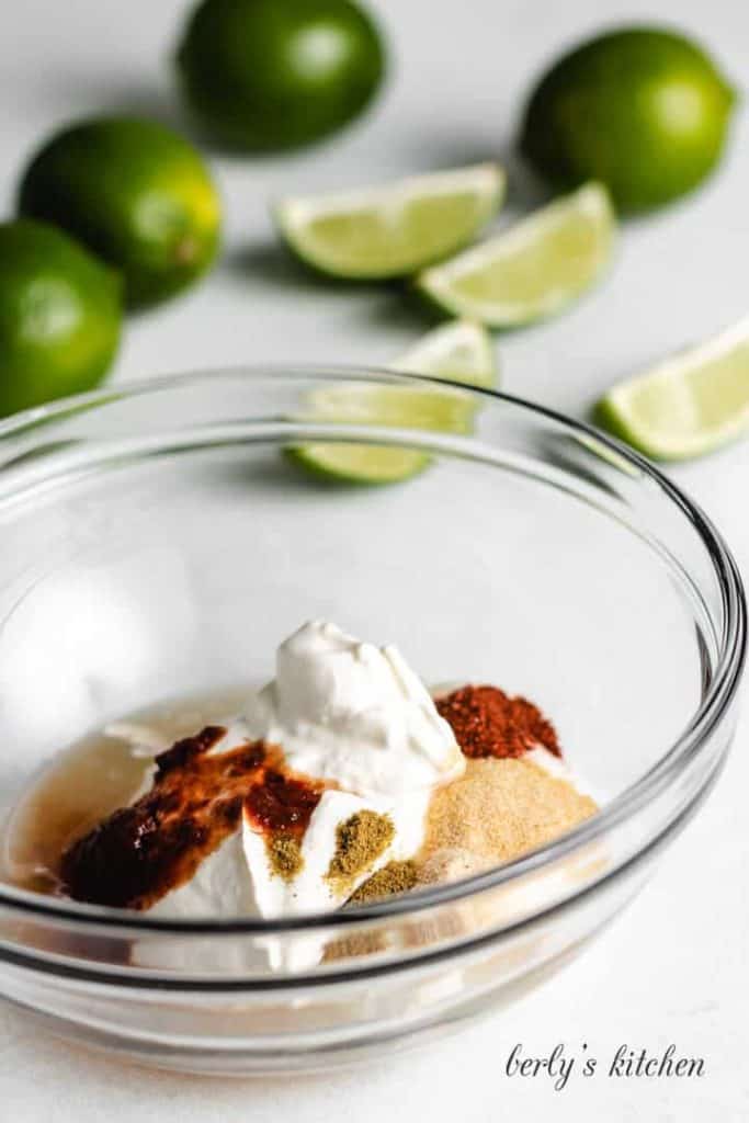 Sour cream, lime juice, and other ingredients in a small mixing bowl.