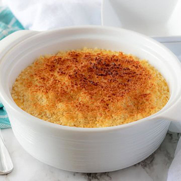 Casserole dish filled with funeral potatoes topped with toasted breadcrumbs.