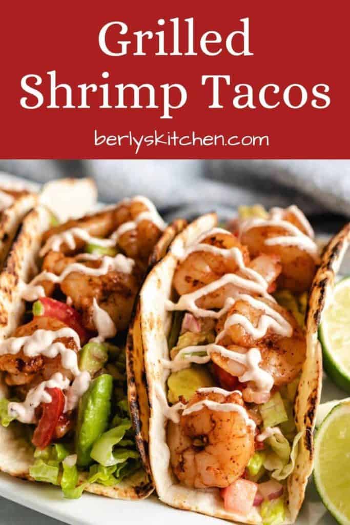A close-up of the grilled shrimp tacos topped with chipotle cream sauce.