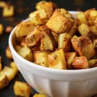 White bowl with oven baked home fries.