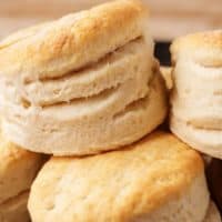 Large stack of homemade biscuits on cast iron.